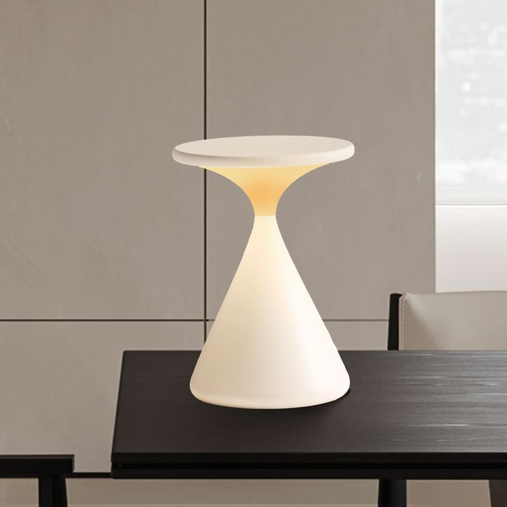 White cordless aluminum table lamp with touch dimmer on bedside table