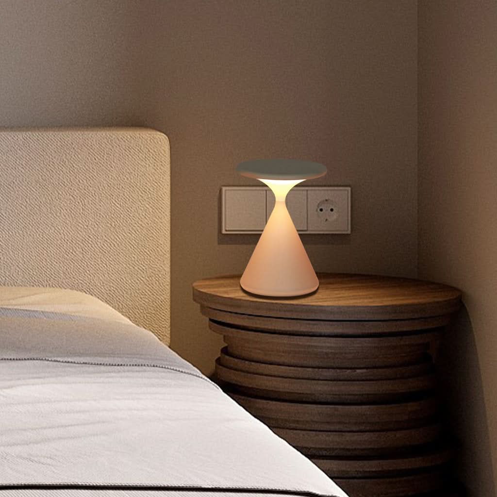 Aluminum table lamp warm glow in bedroom setting