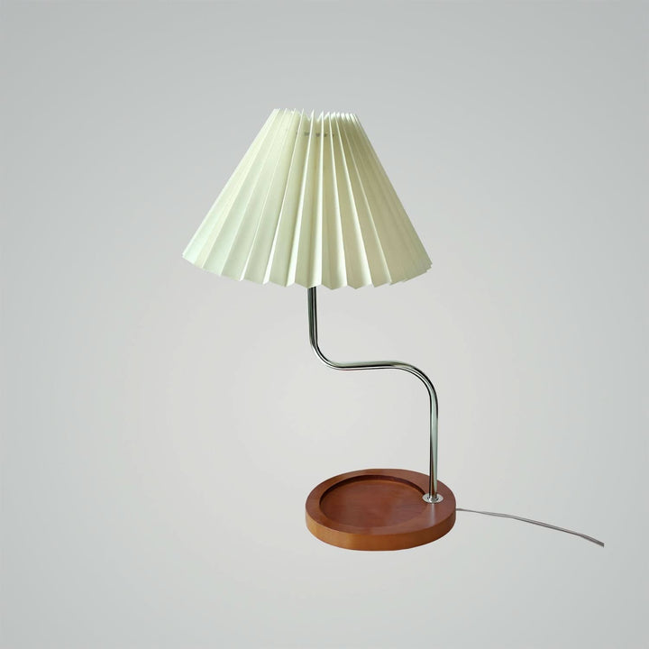 Dark blue pleated lamp casting warm glow in cozy bedroom