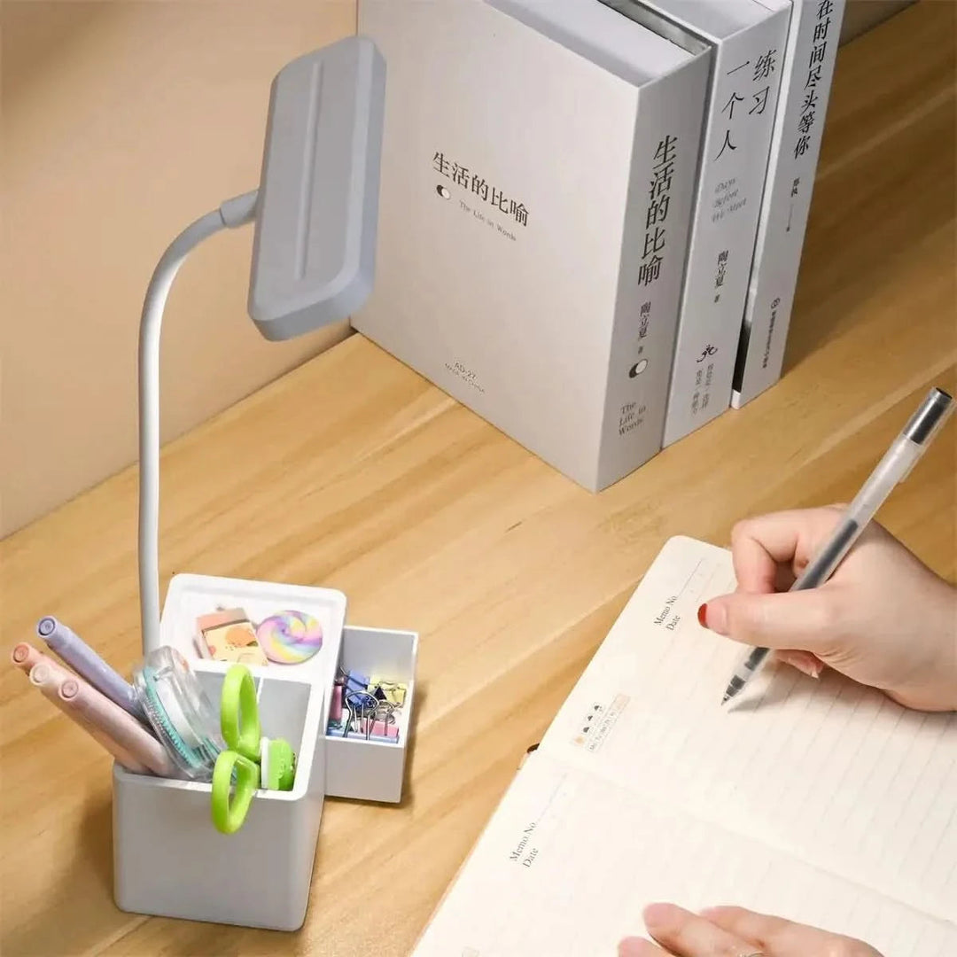 LED desk lamp with built-in phone holder on wooden desk