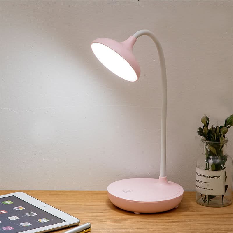 Pink pastel rechargeable desk lamp on white nightstand