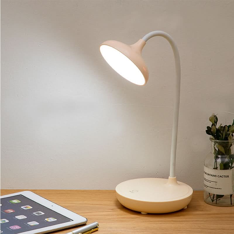 Pink cordless LED desk lamp close-up of touch control base