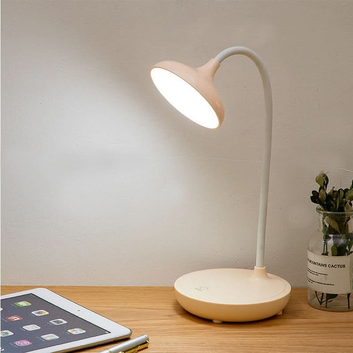 Pink cordless LED desk lamp close-up of touch control base